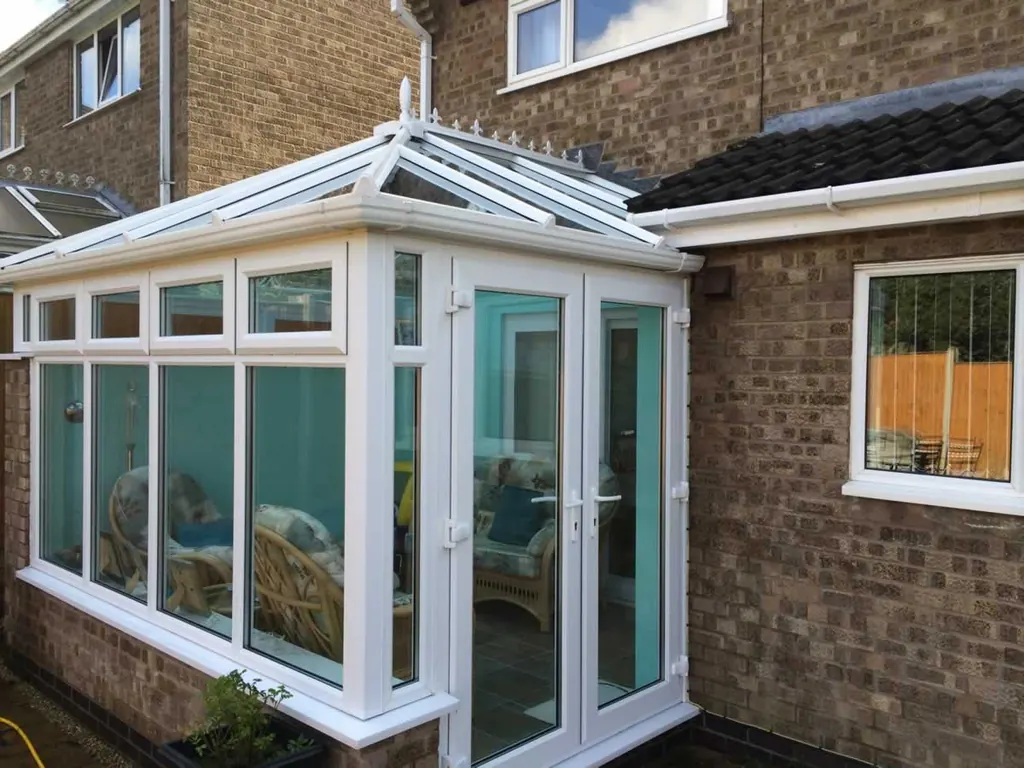 Conservatory with clean glass and white UPVC frames cleaned by Lanes Ltd