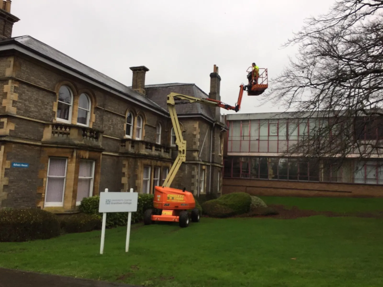 Lanes Ltd cherry picker set up beside a commercial building for high level cleaning