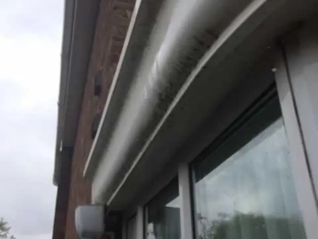 Clean white UPVC fascia and guttering above a window after cleaning by Lanes Ltd